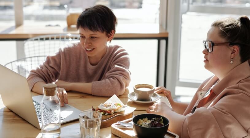 Two people collaborating and learning together at a table